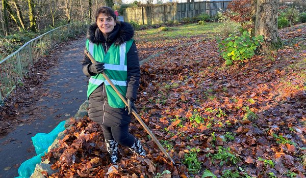 Pam clearing leaves with Milngavie in Bloom volunteers
